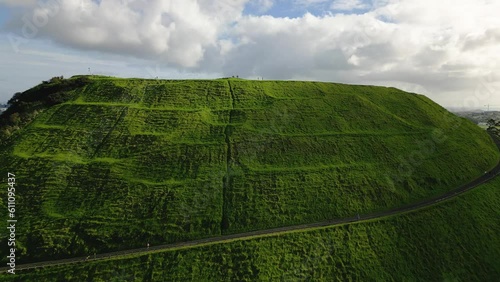 Mount Wellington Auckland. Aerial drone footage rising over hill to expose city skyline. 