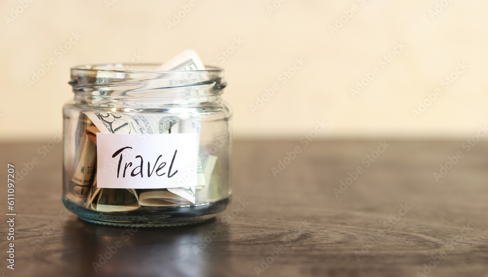 Piggy bank with dollars for travel. Accumulation of financial concept. Saving. Glass jar with money Piggy bank with dollars for travel. Accumulation of financial concept. Saving. Glass jar with money