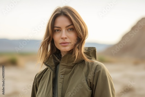 Medium shot portrait photography of a glad girl in her 30s wearing a durable parka against a picturesque desert oasis background. With generative AI technology © Markus Schröder