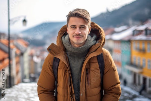 Lifestyle portrait photography of a satisfied boy in his 30s wearing a warm parka against a picturesque old town background. With generative AI technology