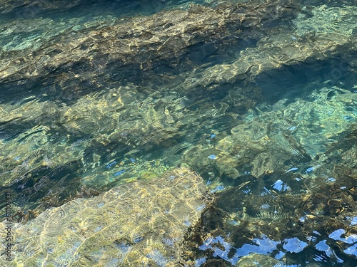 Sea water aqua stones underwater background.