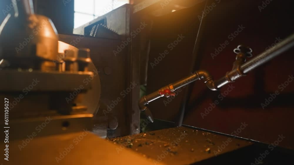 Lathe machine with rotating drum and connected cooling pipe in production factory workshop slow motion. Old metal cutting and grinding equipment closeup Lathe machine with rotating drum and connected cooling pipe in production factory workshop slow motion. Old metal cutting and grinding equipment closeup