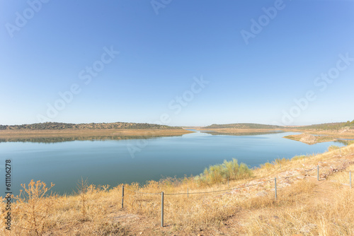 View of swamp. The water level is somewhat low due to lack of rain. Meadow is dry and yellowish. Alange, Extremadura, Spain. © Mer