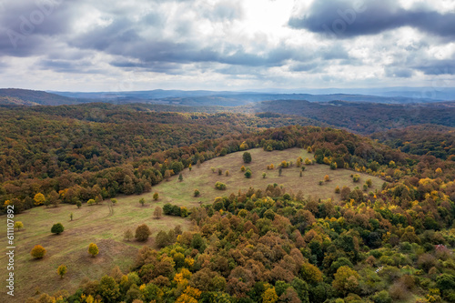 aerial view of mountain and valley covered with autumn colors.