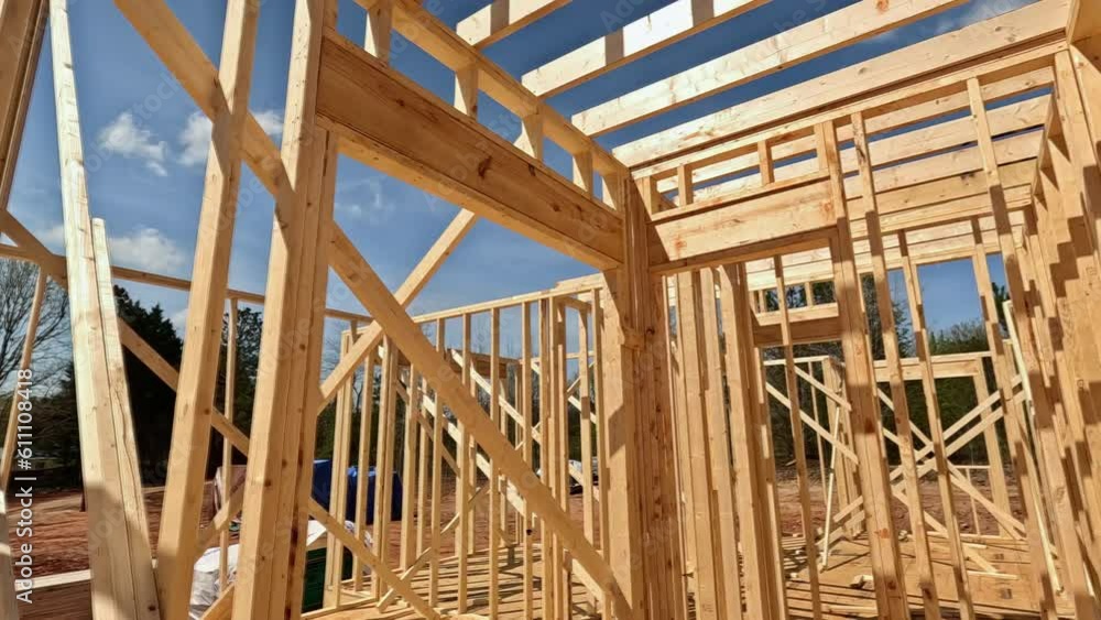 Construction new house involves use of wooden beams as support within frame Construction new house involves use of wooden beams as support within frame