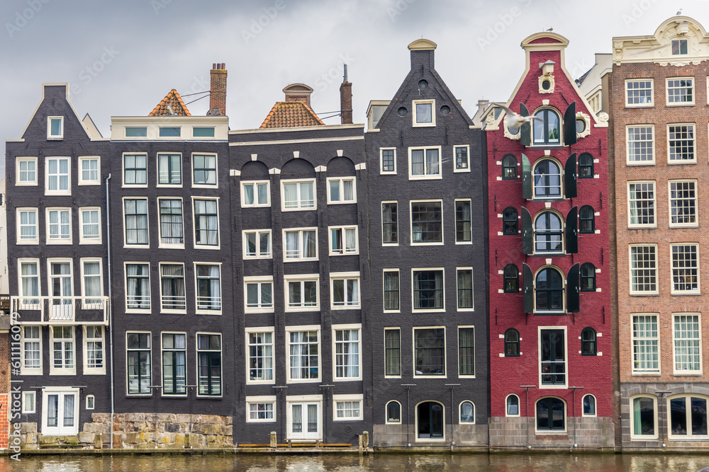 front view buildings amsterdam holland canal crooked buildings