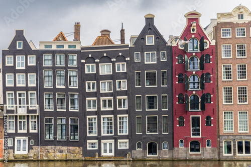 front view buildings amsterdam holland canal crooked buildings