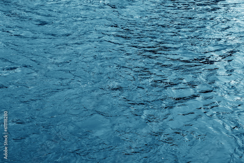 The texture of the water of the river. Natural water background with ripples and waves.