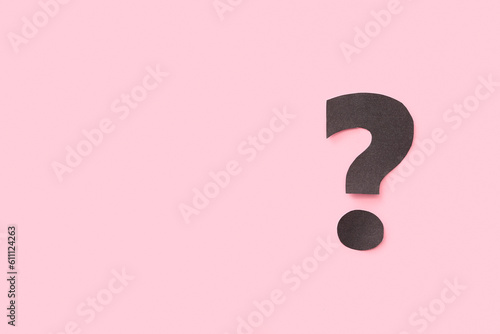 Paper question mark on pink...