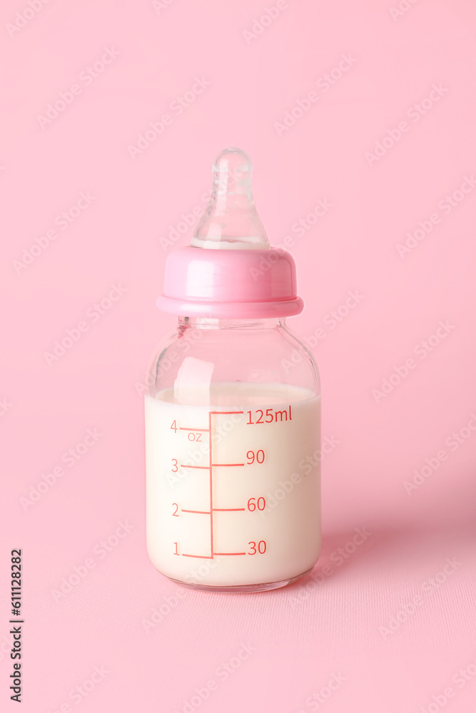 Bottle of milk for baby on pink background Bottle of milk for baby on pink background