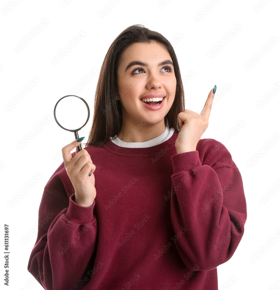Young woman with magnifier pointing at something on white background Young woman with magnifier pointing at something on white background