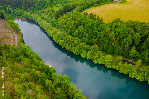 Aerial view of green summer forest and blue river