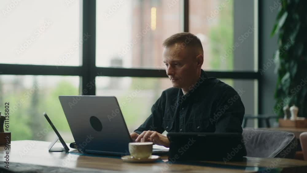 Web Developer Or Business Analyst Working Remotely, Smart Man With Few Gadgets Working In Cafe Web Developer Or Business Analyst Working Remotely, Smart Man With Few Gadgets Working In Cafe