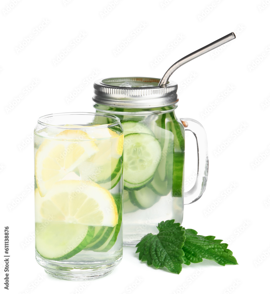 Glass and mason jar of infused water with cucumber slices on white background Glass and mason jar of infused water with cucumber slices on white background