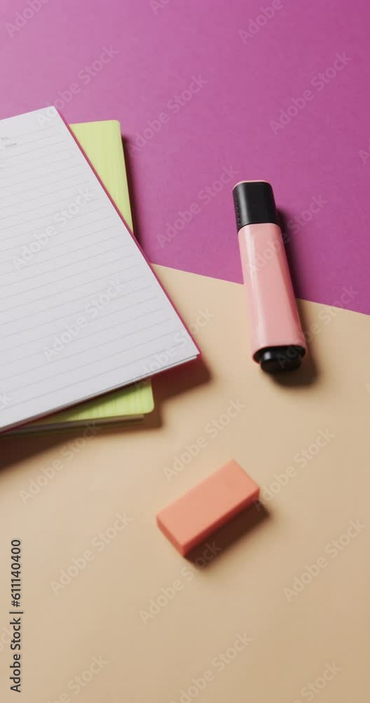 Vertical video of close up of school stationery on purple and beige background, in slow motion Vertical video of close up of school stationery on purple and beige background, in slow motion
