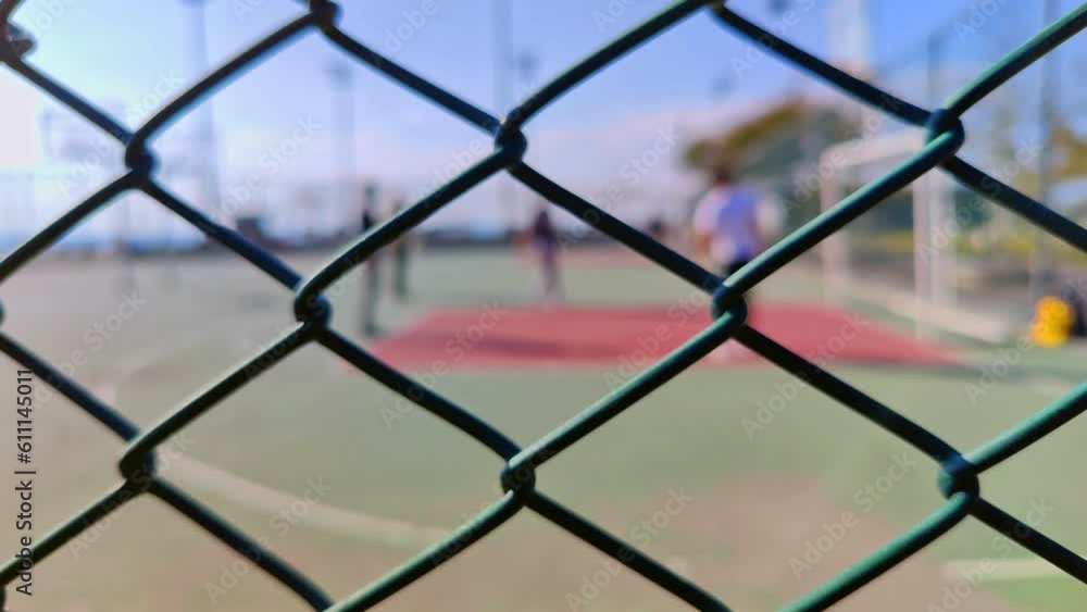 People Playing Outdoors on Iron Fence Basketball Court Footage. People Playing Outdoors on Iron Fence Basketball Court Footage.