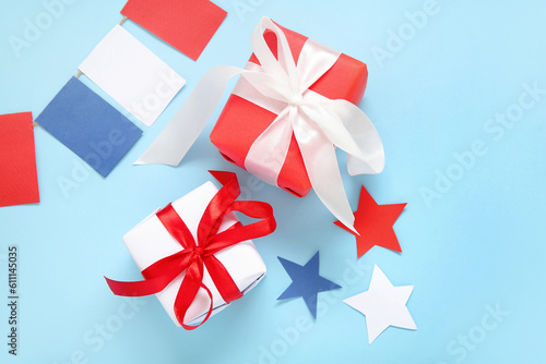 Gift boxes with garland and stars on blue background. American Independence Day