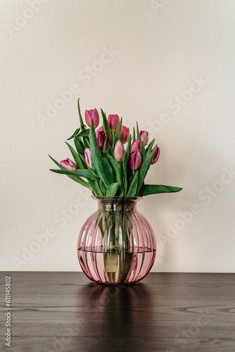 Obraz na płótnie Beautiful spring decoration.Pink purple tulips in glass vase.Fresh tulip flowers bouquet.View with copy space.Greeting card.Woman Mothers Day.Minimalistic bouquet of flowers.Home decoration w salonie