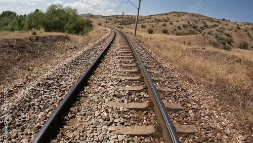 4K time lapse of train moving on railways in sunny daylight. Train passing by remote rural and urban areas stock video.
