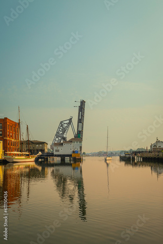 Mystic River Bascule Bridge rising up while yachts and boats wait to pass, summer coastal landscape in Connecticut