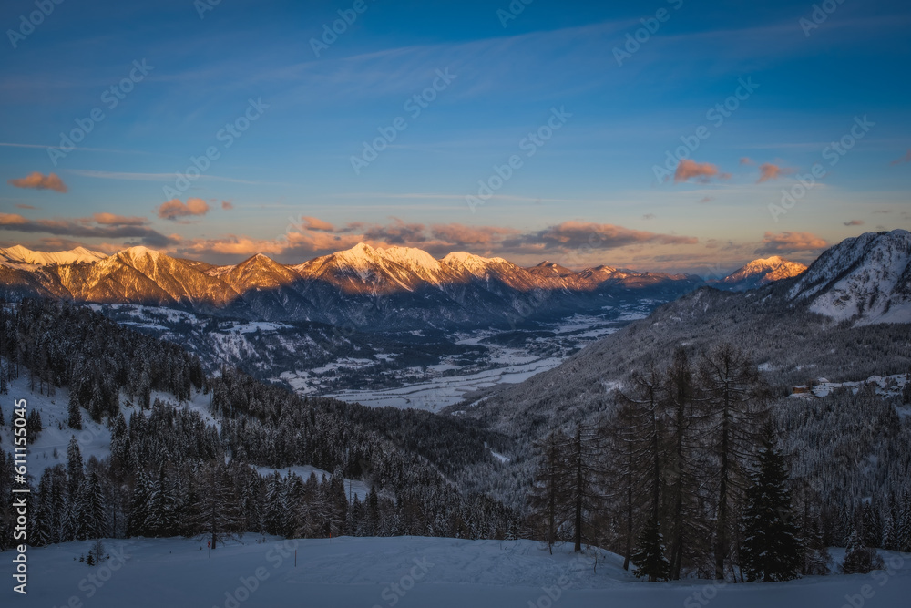 Alpenglow at sunset time on mountain peak at Nassfeld ski resort, Carinthia, Austria. January 2022