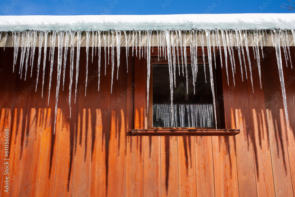 Close up of icicles forming on ledge of roof in winter. Close up of icicles forming on ledge of roof in winter.