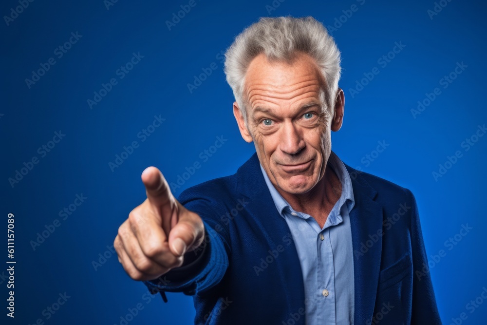 Medium shot portrait photography of a glad mature man pointing up against a royal blue background. With generative AI technology Medium shot portrait photography of a glad mature man pointing up against a royal blue background. With generative AI technology