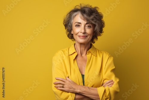 Close-up portrait photography of a satisfied mature woman putting hands on hips against a mustard yellow background. With generative AI technology