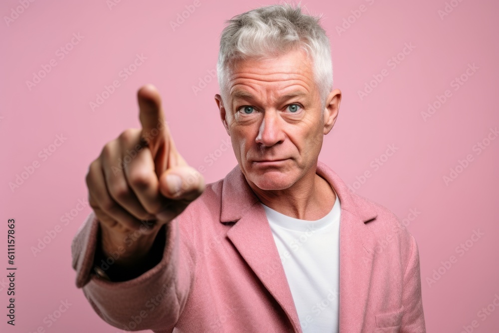 Headshot portrait photography of a tender mature man pointing at oneself with the index finger against a pastel pink background. With generative AI technology Headshot portrait photography of a tender mature man pointing at oneself with the index finger against a pastel pink background. With generative AI technology
