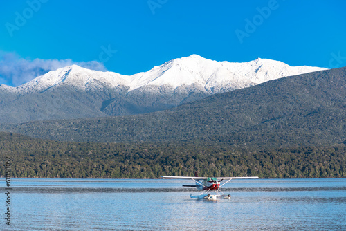 Photograph of a Sea Plane on Te Anau Lake in front of snow capped mountains in the township of Te Anau in Fiordland on the South Island of New Zealand