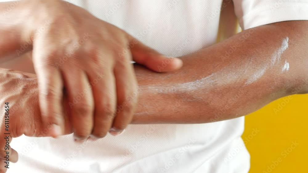 man applying beauty cream onto skin man applying beauty cream onto skin