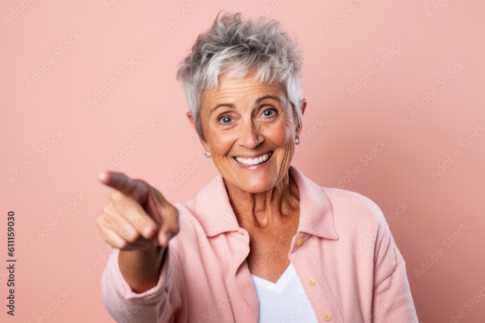 Headshot portrait photography of a grinning mature woman making a i see you gesture pointing at one's eyes against a peachy pink background. With generative AI technology Headshot portrait photography of a grinning mature woman making a i see you gesture pointing at one's eyes against a peachy pink background. With generative AI technology