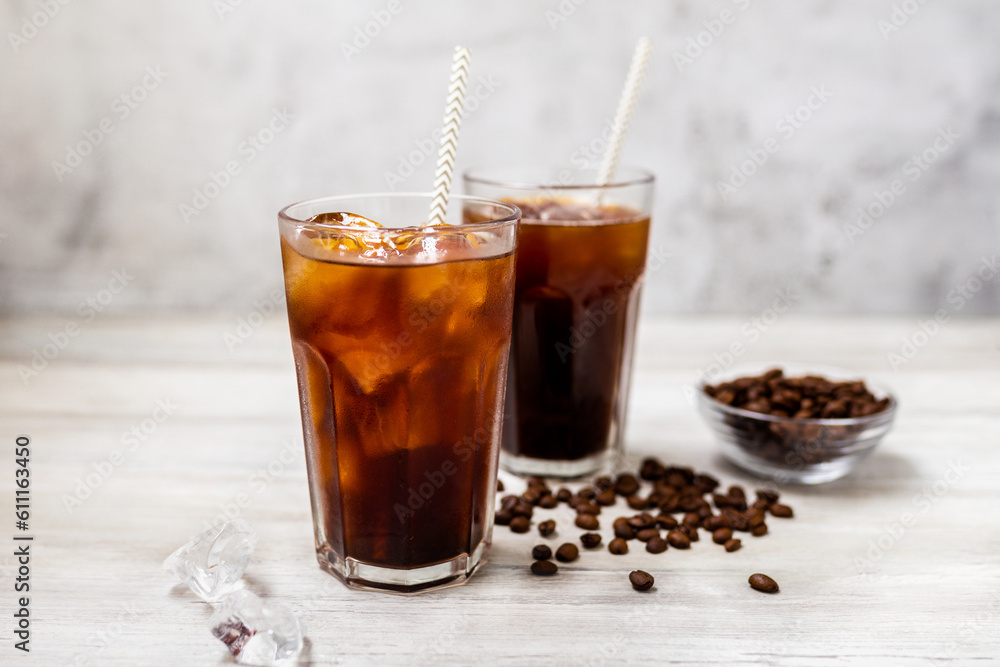 Ice coffee in a tall glass. Cold summer drink on a wooden background with copy space. Ice coffee in a tall glass. Cold summer drink on a wooden background with copy space.