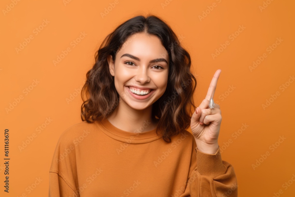 Close-up portrait photography of a grinning girl in her 20s making an ok gesture with the fingers against a pastel orange background. With generative AI technology Close-up portrait photography of a grinning girl in her 20s making an ok gesture with the fingers against a pastel orange background. With generative AI technology