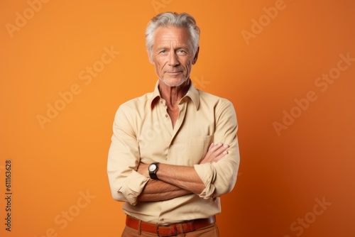 Medium shot portrait photography of a glad mature man putting hands on hips against a pastel orange background. With generative AI technology