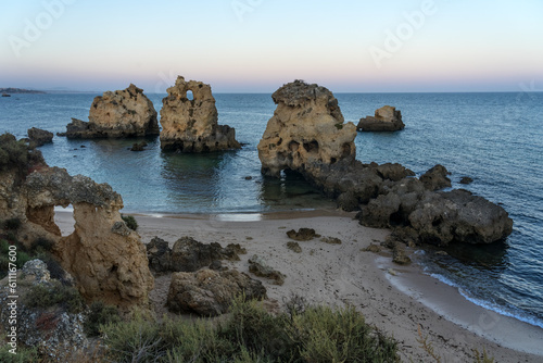 Arrifes beach at sunset in the Algarve region with its famous rock formations, Albufeiroa, Portugal photo