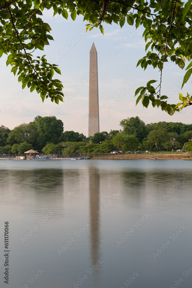Washington Monument at sunset framed by trees