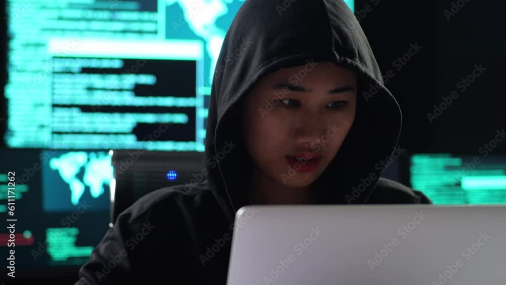 Close Up Of Asian Female Hacker In A Hood Celebrating Succeed Attack Global Infrastructure Servers By A Laptop With Maps And Data On Display Screens Of Multiple Monitors In A Dark Office Room
Close Up Of Asian Female Hacker In A Hood Celebrating Succeed Attack Global Infrastructure Servers By A Laptop With Maps And Data On Display Screens Of Multiple Monitors In A Dark Office Room