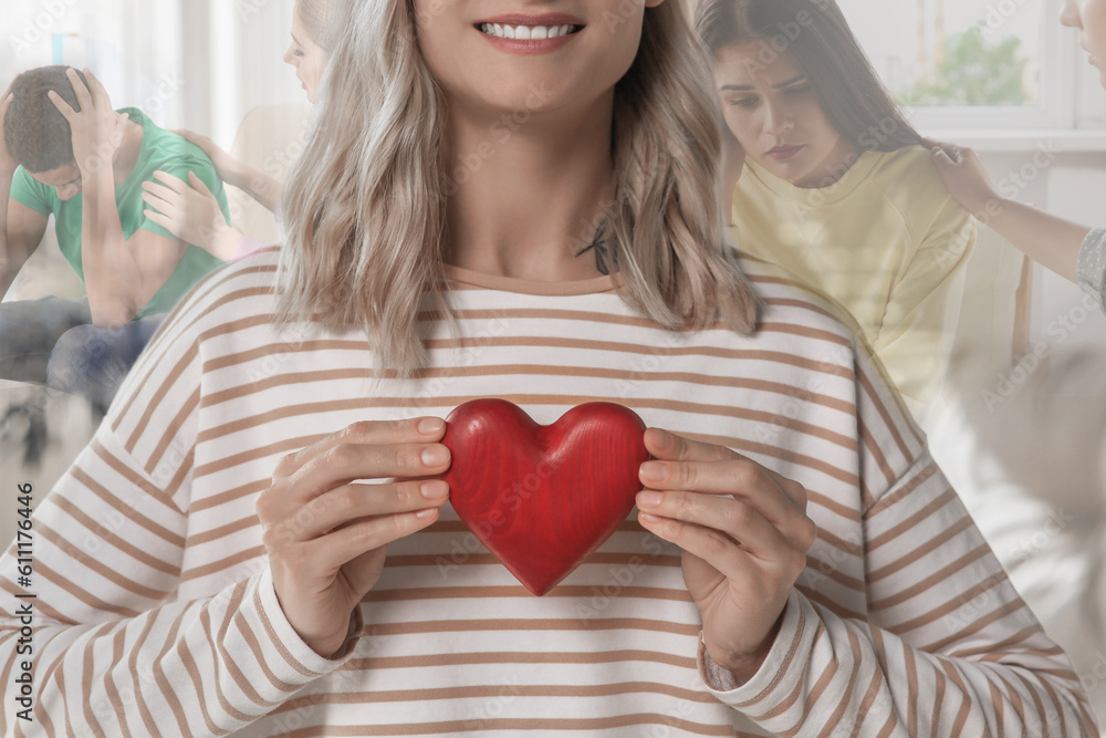 Smiling woman holding red wooden heart as symbol of empathy, closeup. Situations showing need for emotional support on background, double exposure Smiling woman holding red wooden heart as symbol of empathy, closeup. Situations showing need for emotional support on background, double exposure