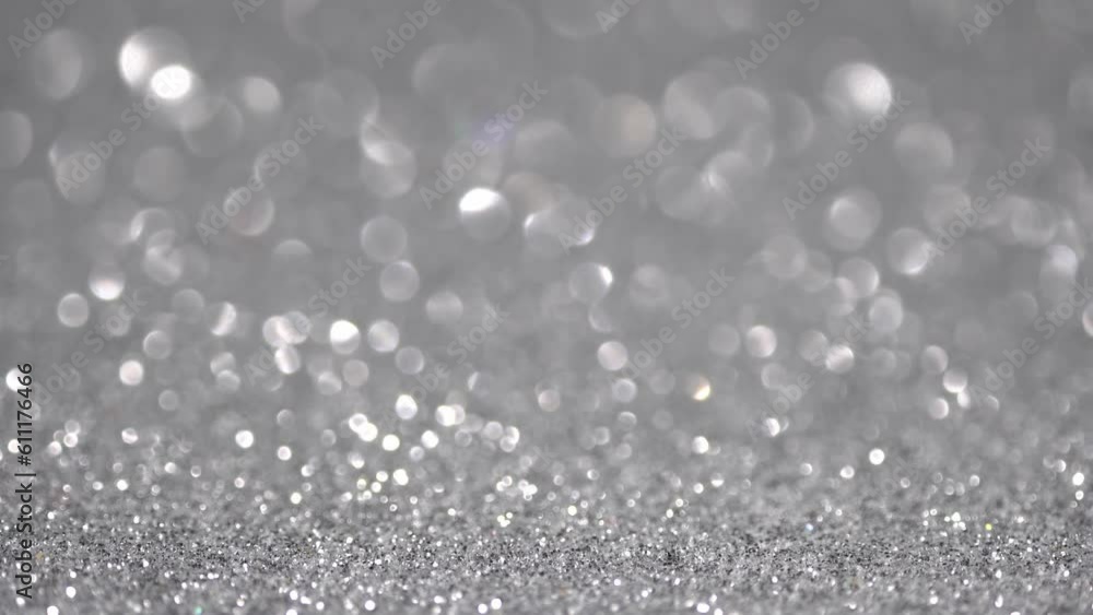 Shiny silver surface rotates. Magic bokeh background Shiny silver surface rotates. Magic bokeh background