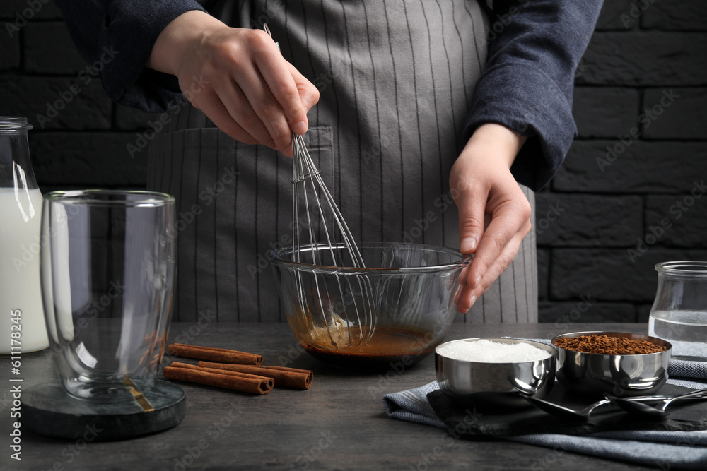 Woman whipping cream for dalgona coffee at grey table, closeup Woman whipping cream for dalgona coffee at grey table, closeup