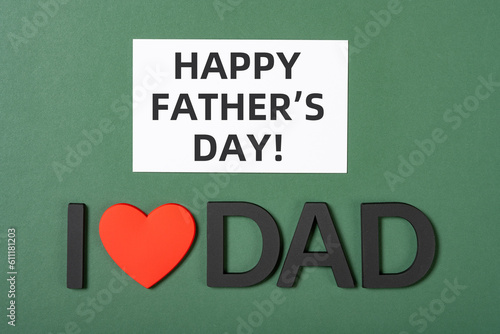 words of I LOVE DAD and card with happy fathers day at horizontal composition