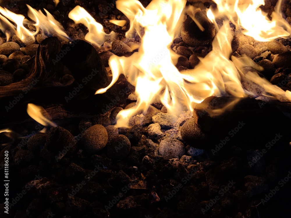 Fire flames in the fireplace, with woods and rocks in close up Stock ...
