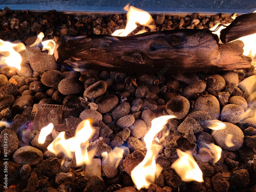 Fire flames in the fireplace, with woods and rocks in close up Stock ...