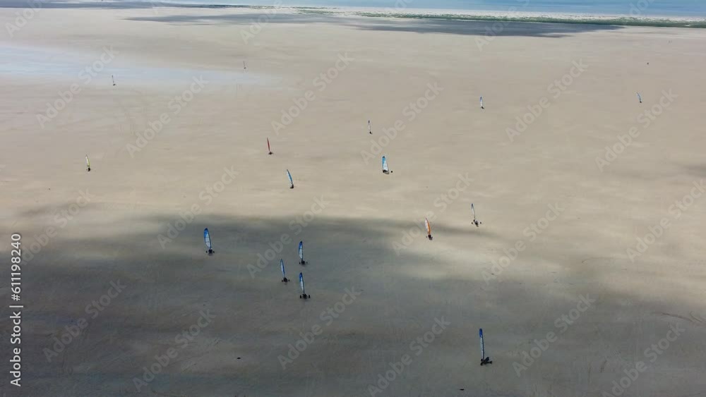 Drone shot people land sailing or sand yachting with blokarts on beach Drone shot people land sailing or sand yachting with blokarts on beach