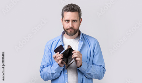 shrugging man hold payment card and wallet in studio. man holding payment card and wallet.