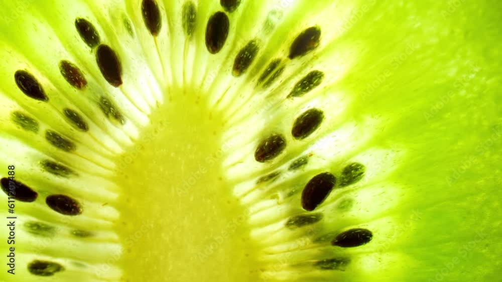 Macro video reveals the vibrant green flesh of a kiwi fruit, showcasing its juicy texture and countless tiny black seeds, inviting a refreshing and tangy taste sensation. Kiwi background. 4K
Macro video reveals the vibrant green flesh of a kiwi fruit, showcasing its juicy texture and countless tiny black seeds, inviting a refreshing and tangy taste sensation. Kiwi background. 4K