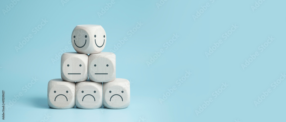 Obraz premium world mental health day concept or feedback rating and positive customer review, wood cube stacking with emotion face icon on blue background