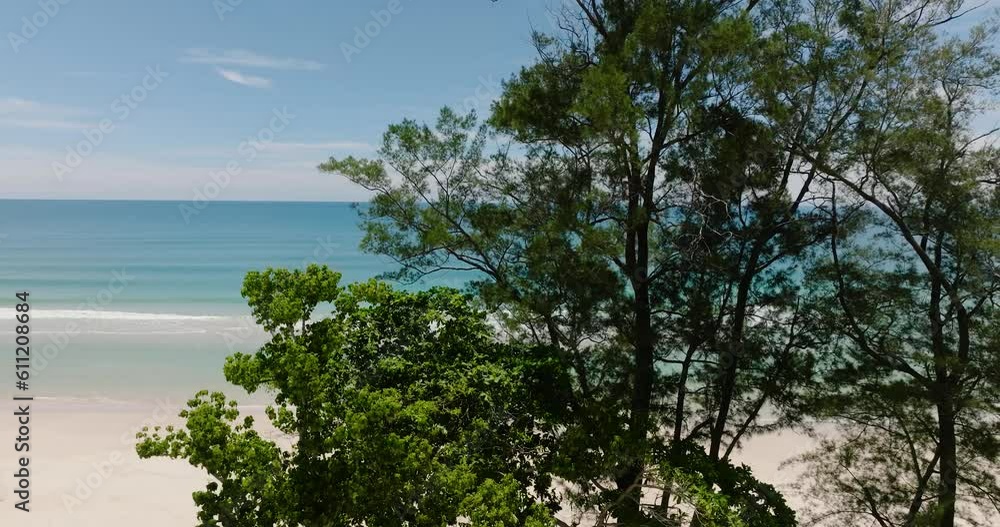 Tropical beach and blue sea through the trees. Sabah, Borneo, Malaysia. Tropical beach and blue sea through the trees. Sabah, Borneo, Malaysia.
