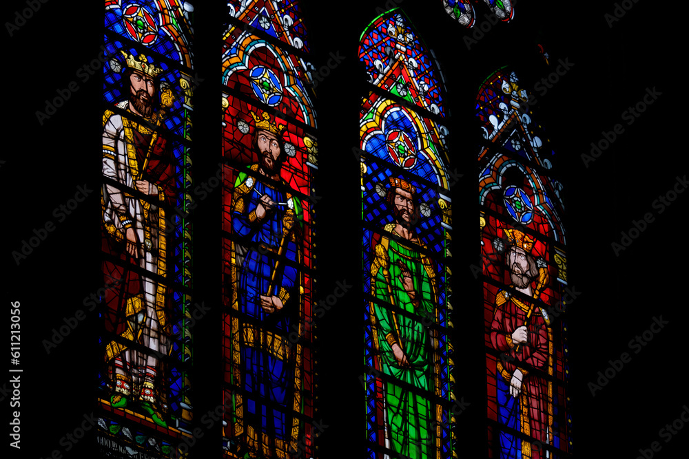 Colorful medieval era stained glass panels depicting monarchs, set in ...